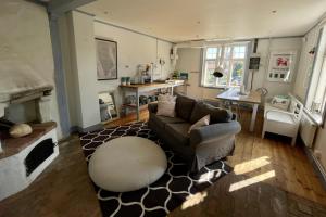 a living room with a couch and a table at 2 Bed House Sleeps 4 with Garden & Free Parking in Ronneby +27 photos