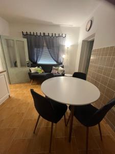 a living room with a table and chairs and a couch at FERIENHAUS Kuća za odmor DJEDIN ORAJ  +18 photos