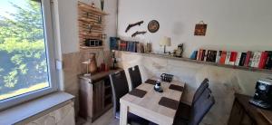 a dining room with a table and chairs and a window at Bungalow Stuebner in Barnin