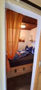 a bedroom with a bunk bed with an orange curtain at Bungalow Stuebner in Barnin