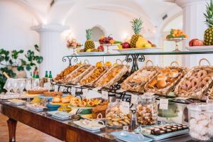 a buffet with many different types of pastries and fruit at Covo Dei Saraceni in Positano
