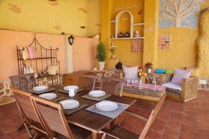 a dining room with a wooden table and chairs at Beautiful Alamedas - el arte de descansar entre jardines y viñedos in Castronuño +75 photos