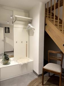 a room with a sliding glass door and a chair at Modernes Häusle in Segnitz I Main & Wein in Segnitz