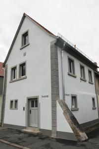 a white building with a door on the side of it at Modernes Häusle in Segnitz I Main & Wein in Segnitz
