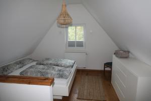 a white room with a bed and a window at Modernes Häusle in Segnitz I Main & Wein in Segnitz