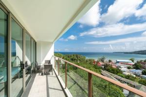 an ocean view from the balcony of a house at Elegant 2BR Oceanview Condo Oceana C73 - 5 min walk Kamala Beach in Kamala Beach