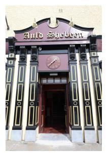 a building with a clock on the front of it at Auld Shebeen in Moate
