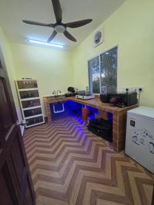 a kitchen with a counter and a ceiling fan at Kabin Bangau Parit in Temerloh