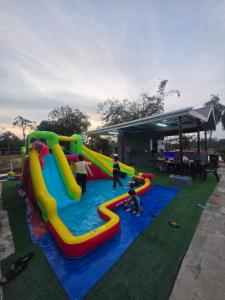 a group of people playing in an outdoor play area at Kabin Bangau Parit in Temerloh