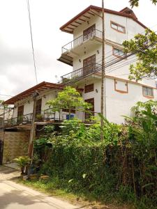 a white house with balconies on the side of it at GT Homes Peradeniya 