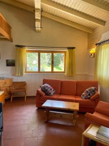 a living room with a couch and a table at Casa nel Bosco in Trento