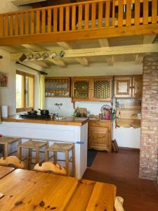 a kitchen with wooden cabinets and a table and a counter at Casa nel Bosco in Trento