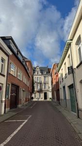 an empty street in a city with buildings at Appartment in Lier City Center in Mellet