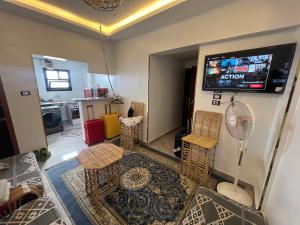 a living room with chairs and a tv on the wall at Super Elite apartments & Studios - Aswan city center apartments in Aswan