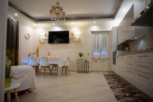 a kitchen and dining room with a table and chairs at Nuova Fiera di Roma in Ponte Galeria