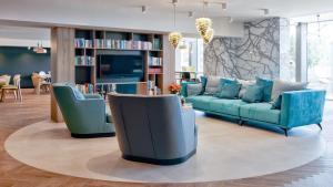 a living room with a couch and two chairs at B&B HOTEL Tomaszów Lubelski in Tomaszów Lubelski