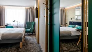 Ένα ή περισσότερα κρεβάτια σε δωμάτιο στο B&B HOTEL Tomaszów Lubelski