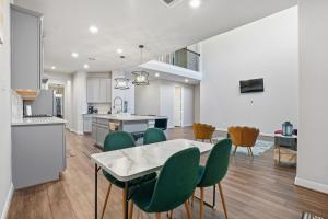 a kitchen and dining room with a table and green chairs at Gorgeous Lake Conroe Home, Affordable Nightly Rent in Keenan