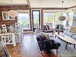 a living room with couches and a table and chairs at Holiday Home Kosestua by Interhome in Madland +31 photos