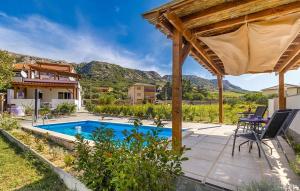 a house with a swimming pool and a pergola at Cozy Apartment In Baska With Swimming Pool in Draga Bašćanska