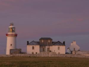 a lighthouse on the shore of a field at Holiday Home Moore Bay - TR4 HH No 14A by Interhome in Kilkee
