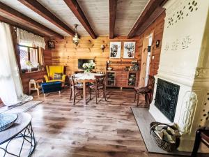 a dining room with a table and a fireplace at Apartment Julia by Interhome in Stoczek