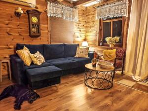 a living room with a blue couch and a table at Apartment Julia by Interhome in Stoczek