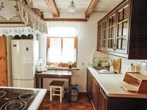 a kitchen with a white refrigerator and a window at Apartment Julia by Interhome in Stoczek +12 photos