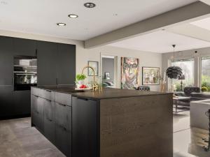 a kitchen with black cabinets and a large island at Villa Frösakull Paradiset by Interhome in Frösakull