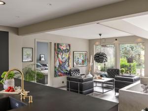 a living room with furniture and a large painting on the wall at Villa Frösakull Paradiset by Interhome in Frösakull