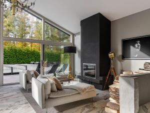 a living room with a couch and a fireplace at Villa Frösakull Paradiset by Interhome in Frösakull