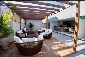 a patio with couches and chairs on a building at Momentos únicos em Foz te esperam in Foz do Iguaçu