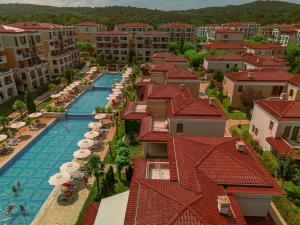 an aerial view of a resort swimming pool with umbrellas at Green Life Apartments Sozopol in Sozopol