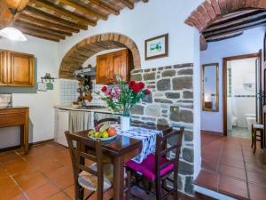 a kitchen and dining room with a table and chairs at Apartment Nido by Interhome in Trequanda