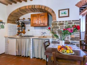 a kitchen with a table with a bowl of fruit at Apartment Nido by Interhome in Trequanda +37 photos