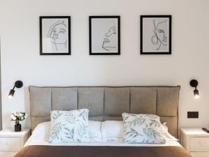 a bedroom with a bed with four pictures on the wall at Holiday Home Poggio Piero 1 by Interhome in Montemassi