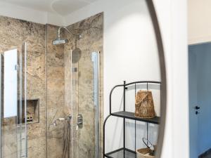 a bathroom with a shower with a glass door at Holiday Home Poggio Piero 1 by Interhome in Montemassi +23 photos