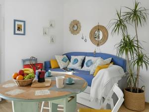 a living room with a blue couch and a table at Apartment Iris 5- Terza Spiaggia by Interhome in Golfo Aranci