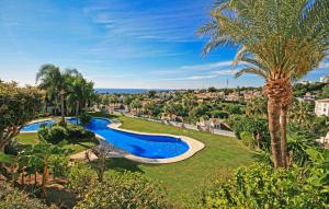 an aerial view of a resort with a swimming pool and palm trees at El Mirador De Calahonda in La Cala de Mijas
