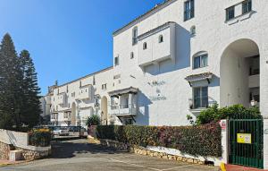 a large white building with bushes in front of it at El Mirador De Calahonda in La Cala de Mijas
