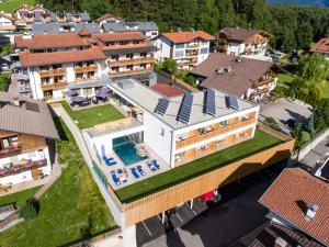 an aerial view of a building with a swimming pool at Hotel Waldrast in Terento
