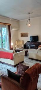 a large living room with couches and a tv at The Pirate's Mansion in Nafplio