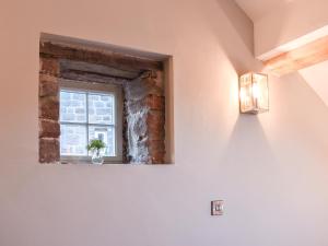 a room with a window with a potted plant at The Barn in Spofforth