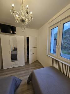 a bedroom with a bed and a chandelier at Altenbeken-Ferienwohnung 2 in Altenbeken