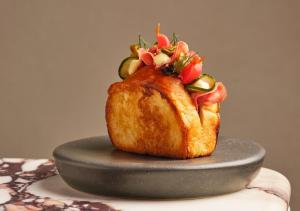 a cake with fruit on top of it on a plate at COMO Metropolitan London in London +254 photos
