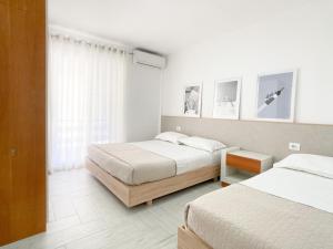 a bedroom with two beds and a window at Nest at the beach in Golem
