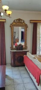 a bedroom with a mirror on a dresser and a bed at The Pirate's Mansion in Nafplio