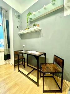 a table and a chair in a room at Tiny Studio in Graz