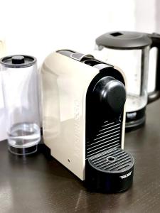 a toaster sitting on a counter next to a glass at Tiny Studio in Graz