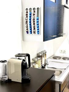 a kitchen counter with a toaster and a sink at Tiny Studio in Graz